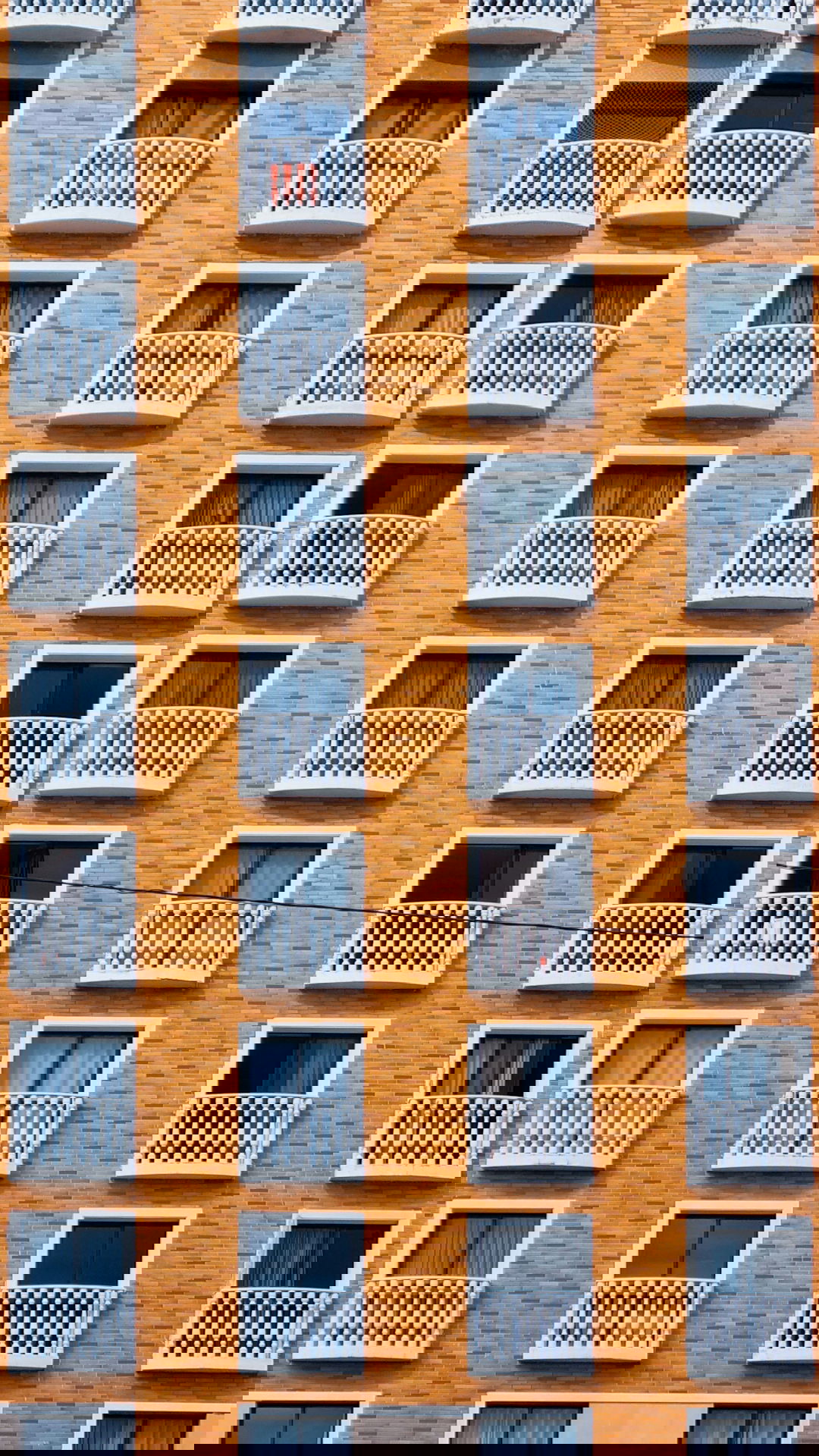 a-tall-brick-building-with-balconies-and-balconies.jpg a tall brick building with balconies and balconies